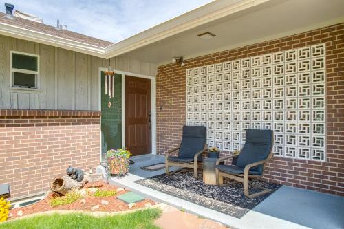 two chairs sitting on the porch of a house at Modern Creekside Home 9 Mi to Downtown Denver in Lakewood