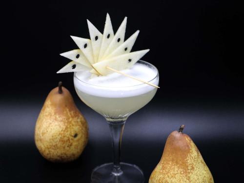 a drink in a glass with two pears at ibis Styles Aix les Bains Domaine de Marlioz in Aix-les-Bains