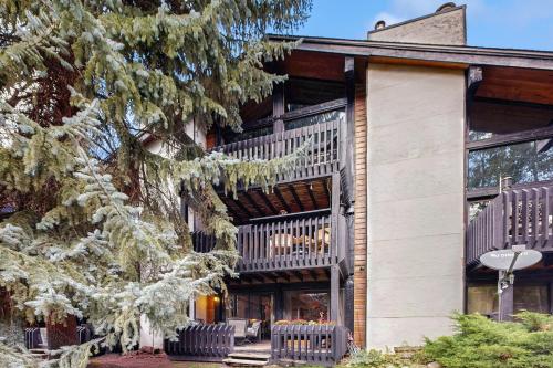 an apartment building with a balcony with chairs at Interlochen #B9 in Vail