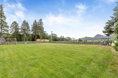 a large grassy field with a soccer goal at 3 Bed in Newtonmore oc-h32416 in Newtonmore