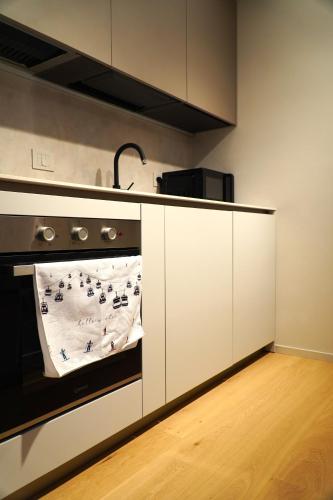 a kitchen with an oven with a towel on it at La Dimora delle Nevi in Aosta