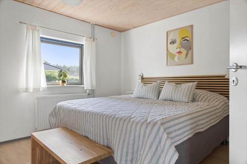 a bedroom with a large bed and a window at 2702-Romo-Drosselvej-13 in Sønderby
