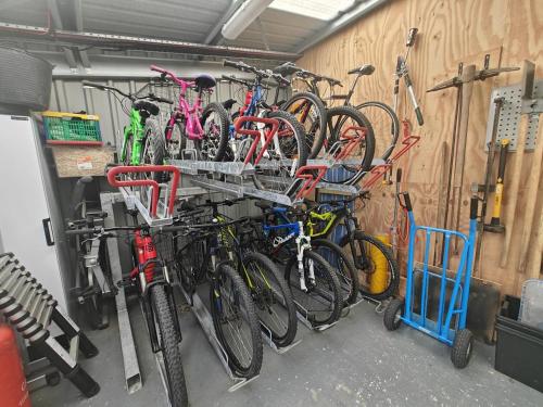a bunch of bikes are hanging on a wall at 2 Bed in Newtonmore oc-e32418 in Newtonmore