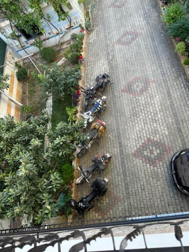 an overhead view of a garden with parked motorcycles at Guesthouse Alemannia in Berat