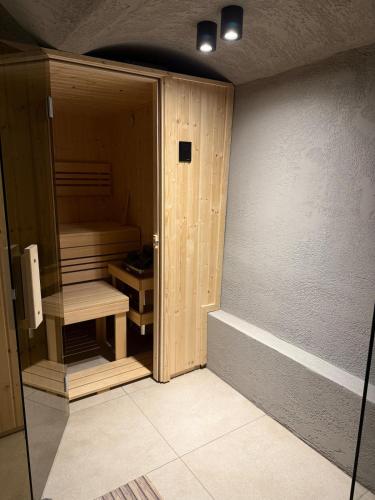 a room with a wooden closet with a bench in it at Chill room PLUS in Golčŭv Jeníkov