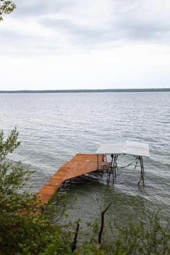 a dock in the middle of a body of water at The Cliff House Hot Tub Kayaks & Game Room in Dresden
