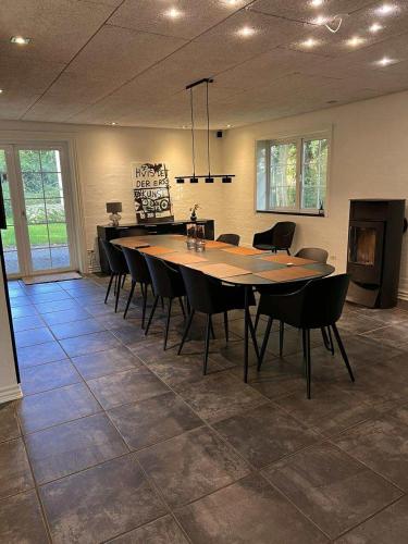 a large dining room with a table and chairs at The house in the countryside close to MCH in Herning
