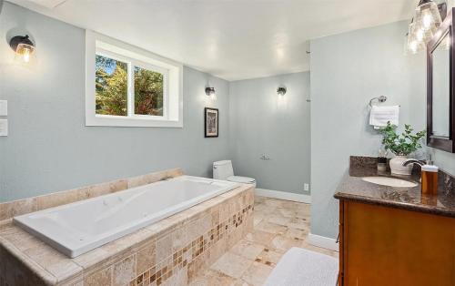 un ampio bagno con vasca e lavandino di Sunlit Ballard Home Close to Golden Garden a Seattle