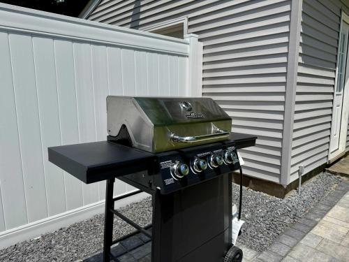 a barbecue grill with a pan on top of it at Jefferson & Grounds 3BR Steps from HWS and Hot Tub in Geneva