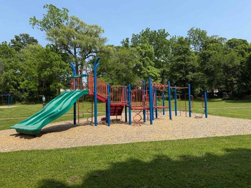 a playground with a slide in a park at Jefferson & Grounds 3BR Steps from HWS and Hot Tub in Geneva