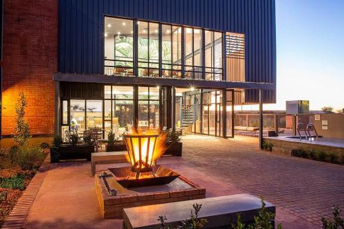 a building with a fountain in front of a building at Kathu Hotel in Kathu