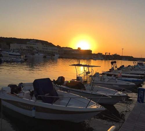 a group of boats docked in a harbor at sunset at Al Giglio - Affittacamere in Cariati