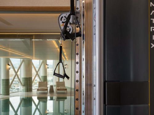a camera on the side of a building with chairs at Sofitel Athens Airport in Athens