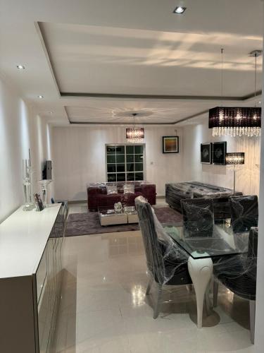 a living room with a table and a couch at Apartamento T3 in Camama