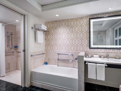 a bathroom with a tub and a sink and a shower at Sofitel Lafayette Square Washington DC in Washington