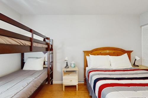 a bedroom with two bunk beds and a night stand at Vail View Dreams in Vail