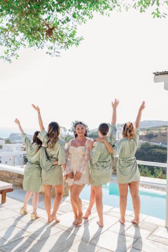 a group of women standing next to a swimming pool at Villa Giulia, Seaview Villa in Ios Chora