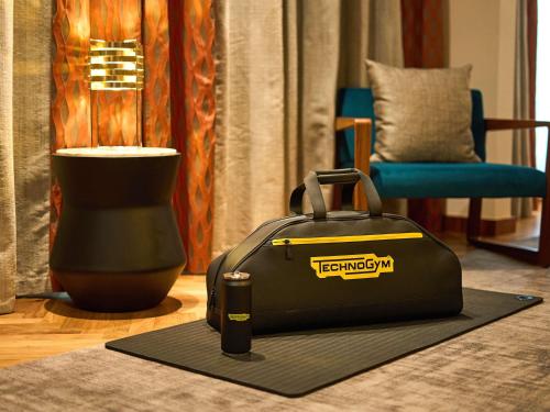 a suitcase sitting on a rug in a living room at Sofitel Warsaw Victoria in Warsaw