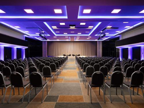 an empty hall with chairs and blue lights at Sofitel Warsaw Victoria in Warsaw