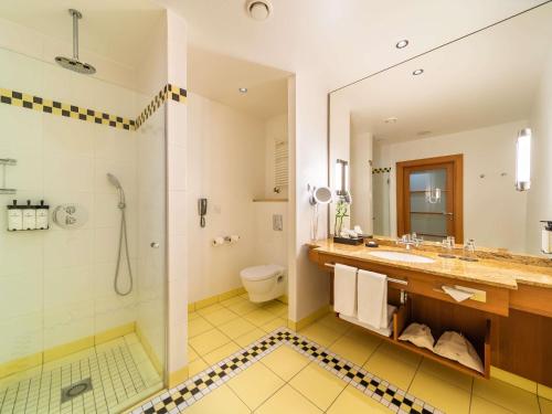 a bathroom with a shower and a sink at Sofitel Grand Sopot in Sopot