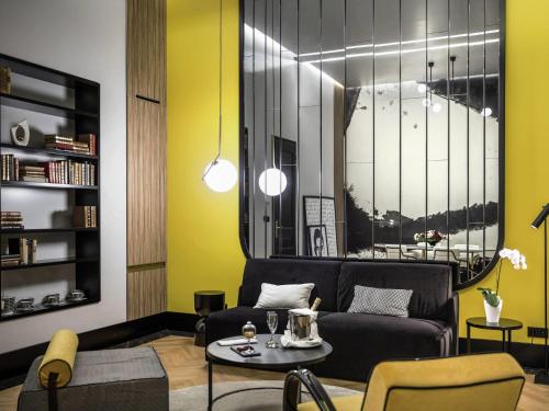 a living room with a couch and a table at Century Old Town Prague - MGallery Collection in Prague