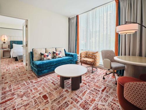 a living room with a couch and a table at Sofitel Montreal Golden Mile in Montréal