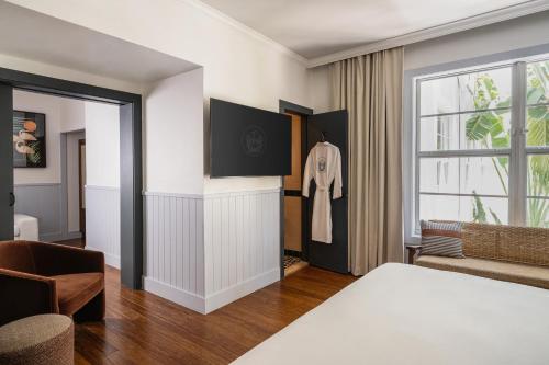 a hotel room with a bed and a window at Balfour Miami Beach, a Morgans Originals hotel in Miami Beach