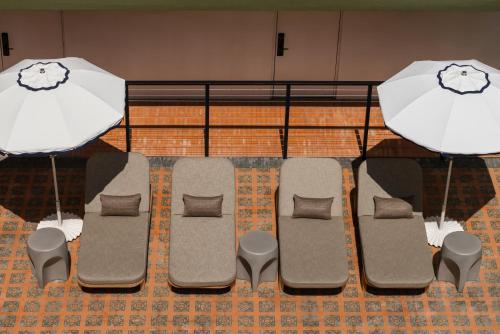 a group of chairs and an umbrella at Balfour Miami Beach, a Morgans Originals hotel in Miami Beach