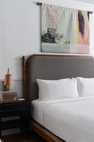 a bedroom with a bed and a picture on the wall at Balfour Miami Beach, a Morgans Originals hotel in Miami Beach