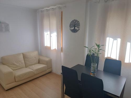 a living room with a table and a couch at Apartamento Nayara in Alcañiz