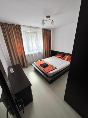 a bedroom with a bed and a window at HomeLand3 in Bîrlad