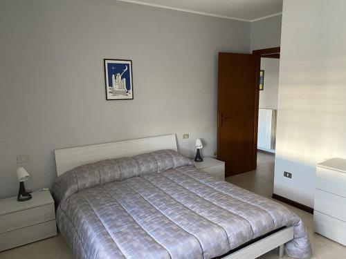 a bedroom with a bed in a white room at Appartamento indipendente Maranello vicino Ferrari in Maranello
