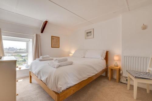 a bedroom with a bed with towels on it at Castle Point Cottage Craster in Craster