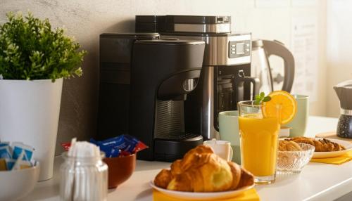 a coffee maker and some food and drinks on a counter at La Clessidra - Rome Ciampino Airport in Ciampino