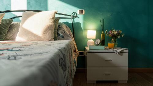 a bedroom with a bed and a night stand with a lamp at La Clessidra - Rome Ciampino Airport in Ciampino
