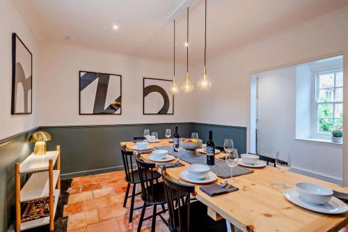 a dining room with a large wooden table and chairs at Red House in Methwold