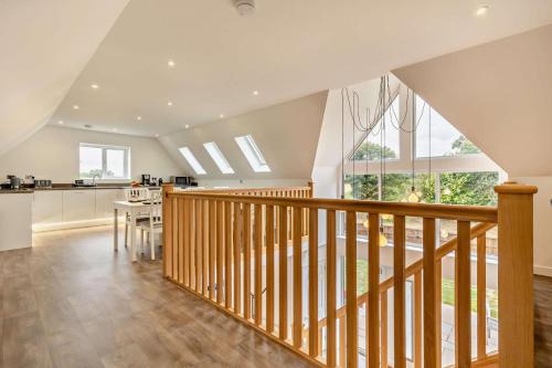 a large kitchen and dining room with a wooden staircase at Pheasant House - Cawston in Cawston