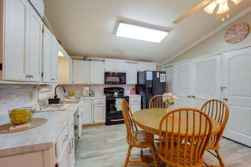 a kitchen with white cabinets and a table and chairs at Mtn Home with Deck and Community Amenities in Newland in Montezuma