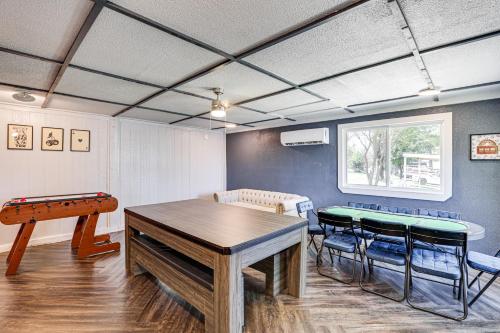 a room with a ping pong table and chairs at Lakefront Escape with Game Room and Dock in Mabank! in Enchanted Oaks