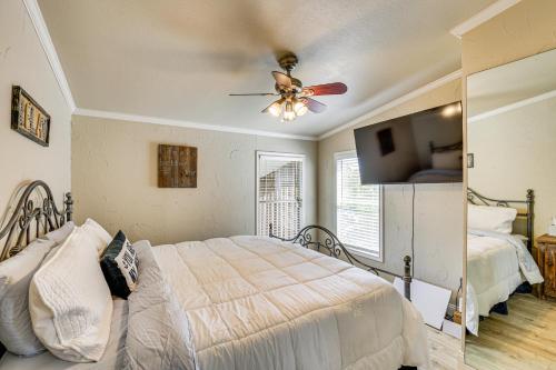 a bedroom with a bed and a ceiling fan at Lakefront Escape with Game Room and Dock in Mabank! in Enchanted Oaks