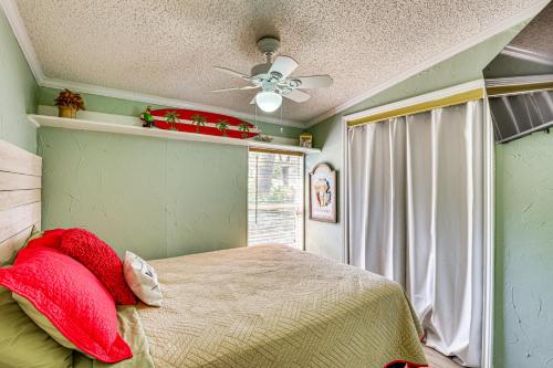 a bedroom with a bed and a ceiling fan at Lakefront Escape with Game Room and Dock in Mabank! in Enchanted Oaks