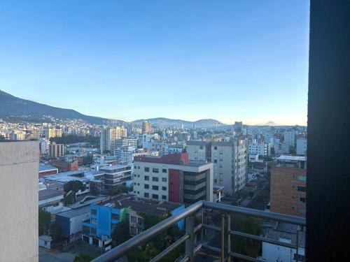 a view of a city from a balcony at Olympus Apartments in Quito