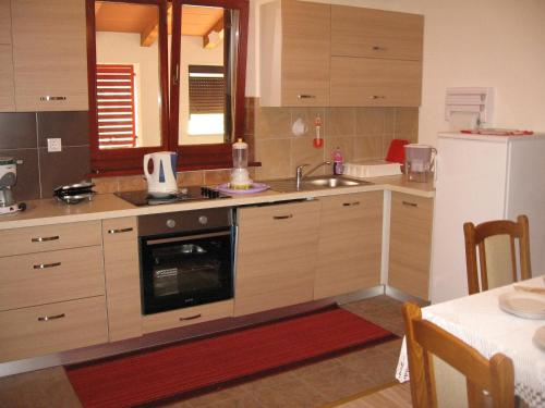 a kitchen with a sink and a stove top oven at Apartments Alen in Pazin