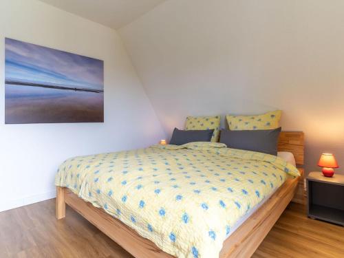 加尔丁Ferienhaus in Garding的卧室里有一张床，墙上挂着一幅画