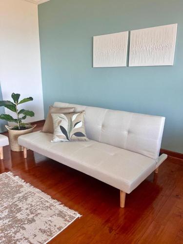 a white couch sitting in a living room at Bo-den-See Guesthouse in Groot Brak Rivier
