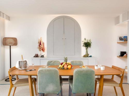 a dining room with a wooden table and chairs at Sofitel Agadir Thalassa Sea & Spa in Agadir