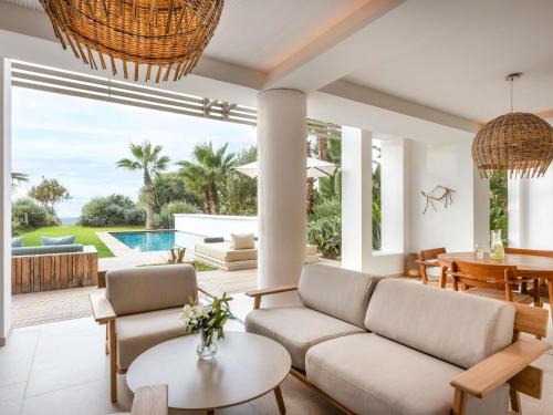 a living room with a couch and a table at Sofitel Agadir Thalassa Sea & Spa in Agadir
