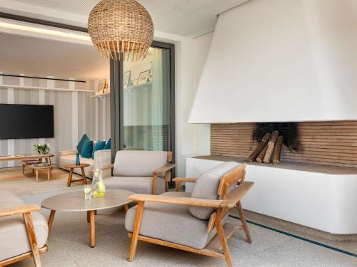 a living room with chairs and a table at Sofitel Agadir Thalassa Sea & Spa in Agadir