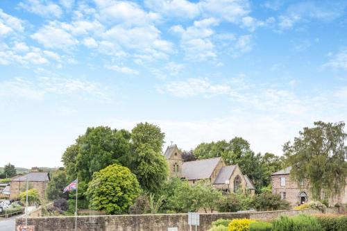 a house in a residential neighborhood with a flag at Lionels Den in Wooler