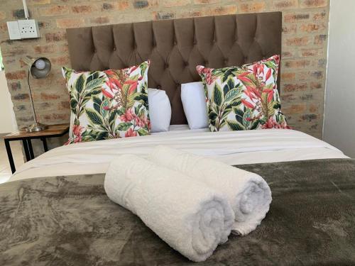 a bed with a white blanket and pillows at Clear Skies in Kempton Park